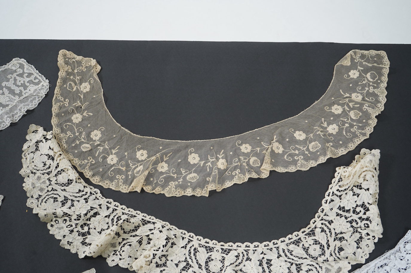 Seven late 19th century collars and trimming, being a long wide length of bobbin lace trimming - 268cm, two similar Bruges cream lace collars, an Irish Carrick-ma-cross collar, a fine needle run collar and another with a